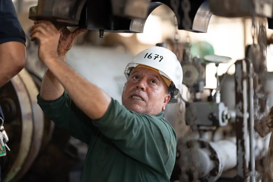 Technician examining commercial gas equipment in a New Braunfels TX business facility